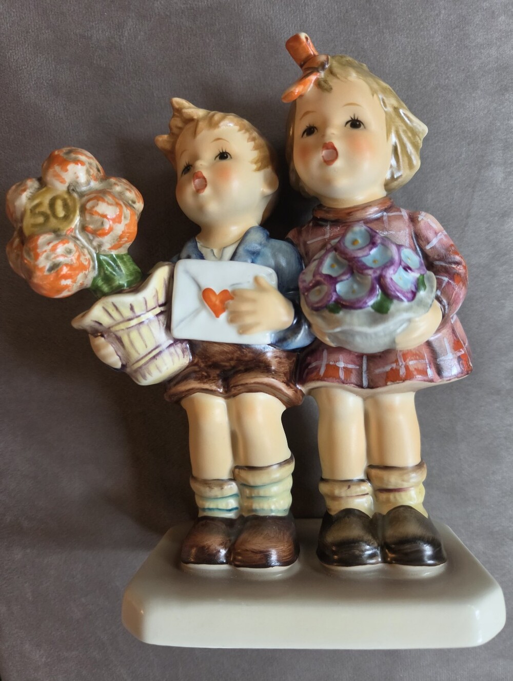 Hummel Porcelain Boy and Girl Figurine - Cream, Orange, Blue, Purple, Brown.
